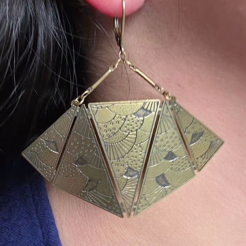 Suuret Amélie Blaise Origami statement-korvakorut puettuna korvaan. Graafiset ranskalaismuotoillut korvakorut Solessa verkkokaupasta.