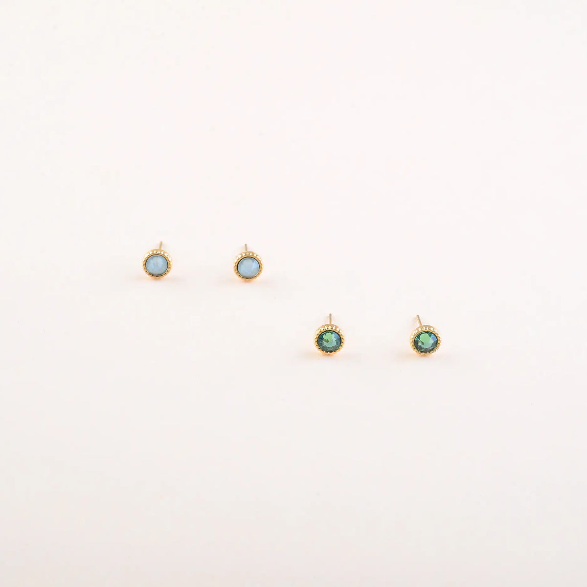 Bohm Paris Maelia kahden parin kullanvärinen kristallikorvakorusetti, jossa on kuvioitu kranssireunus, oliivinvihreät Erinite Green ja vaaleansiniset Pacific Opal Swarovski-kristallit.